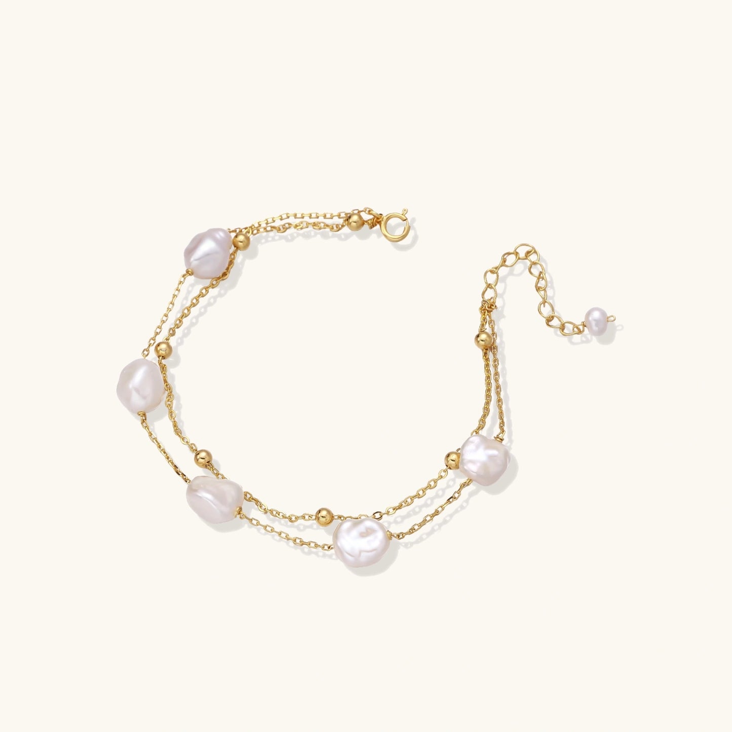 Gold bracelet with pearls on a white background