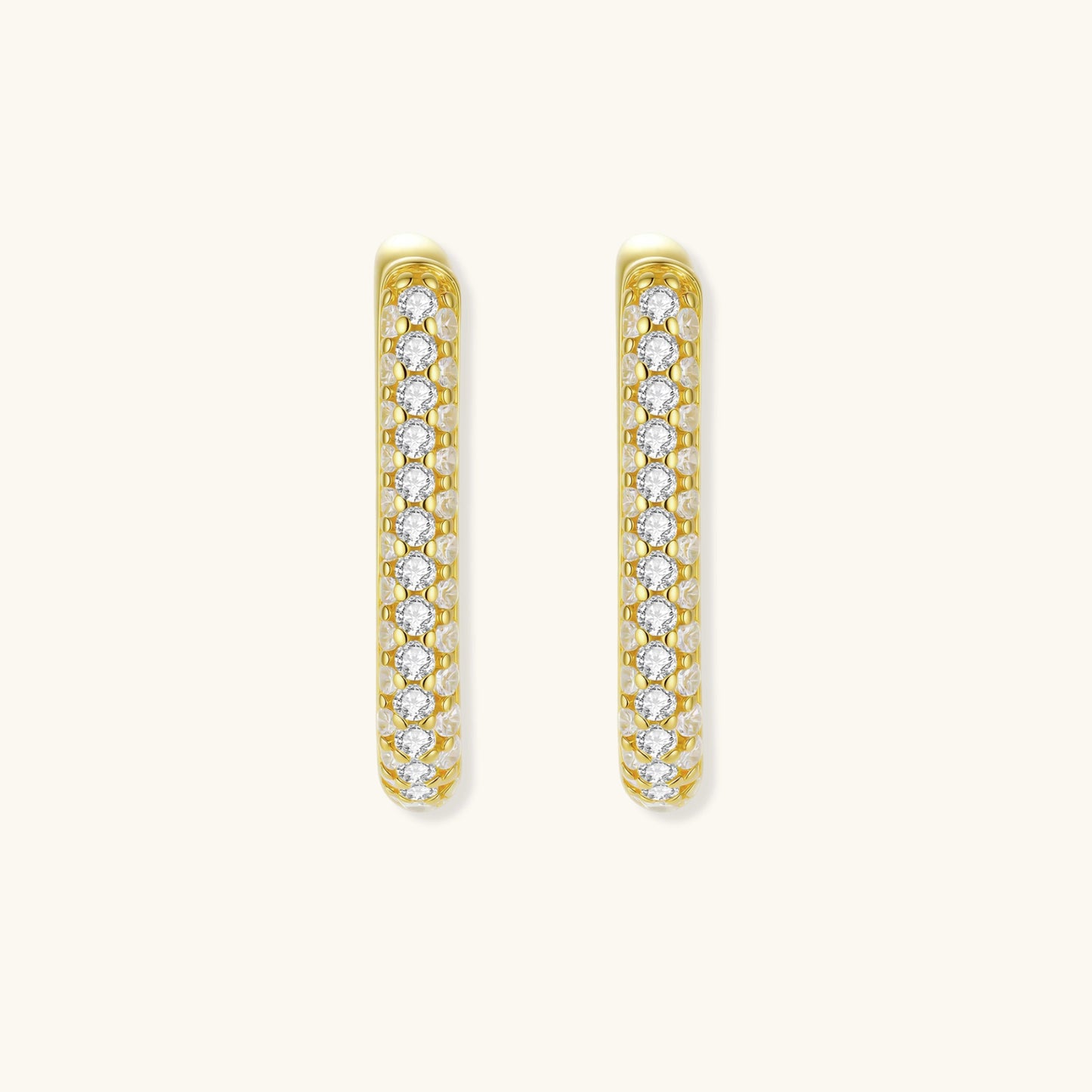 Close-up of small sterling silver huggie hoops completely covered in sparkling clear crystals with hinged closure