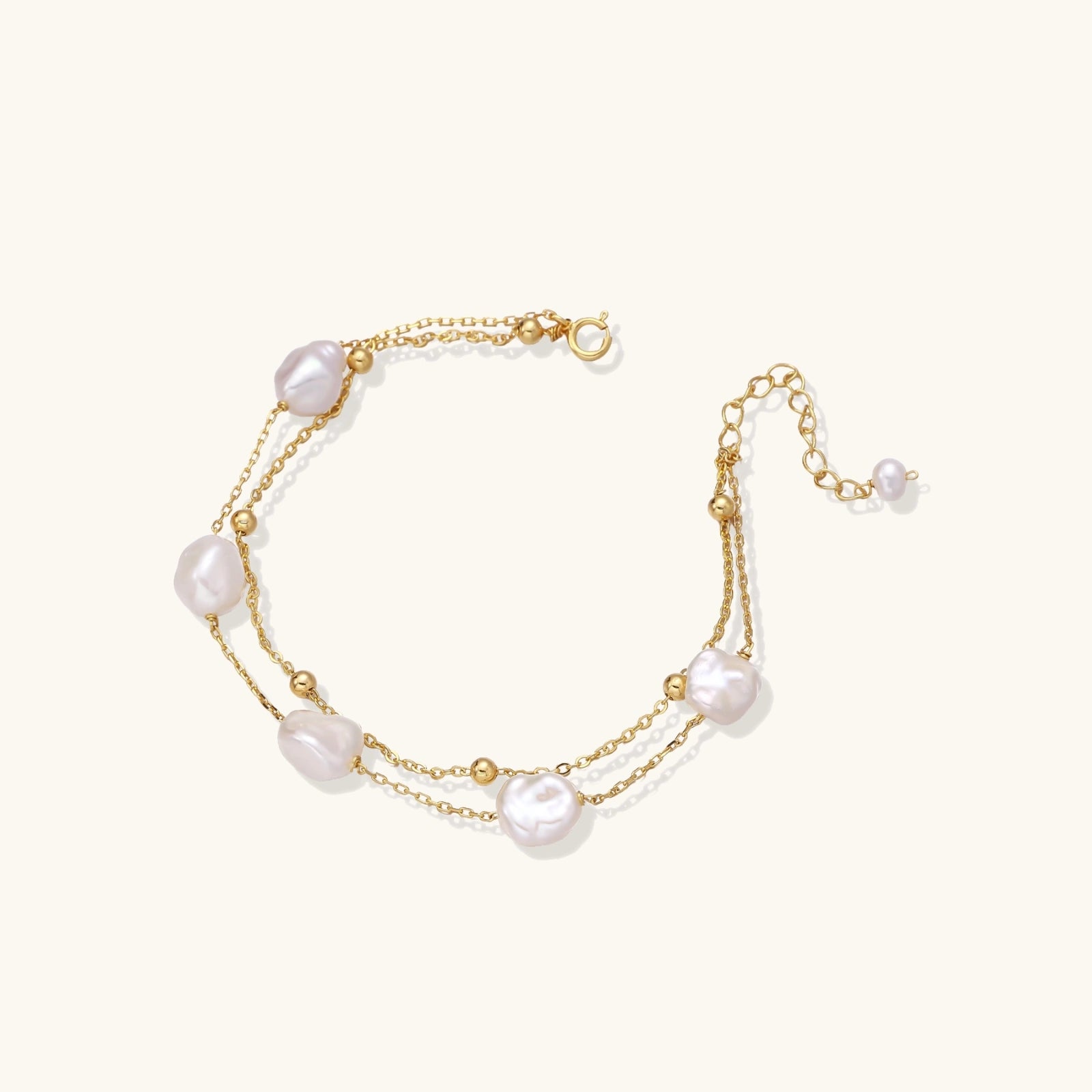 Gold bracelet with pearls on a white background