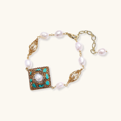 Pearl bracelet with a decorative square clasp on a white background